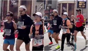 Harry Styles, de moletom preto e bandana branca na cabeça, na Maratona de Tóquio