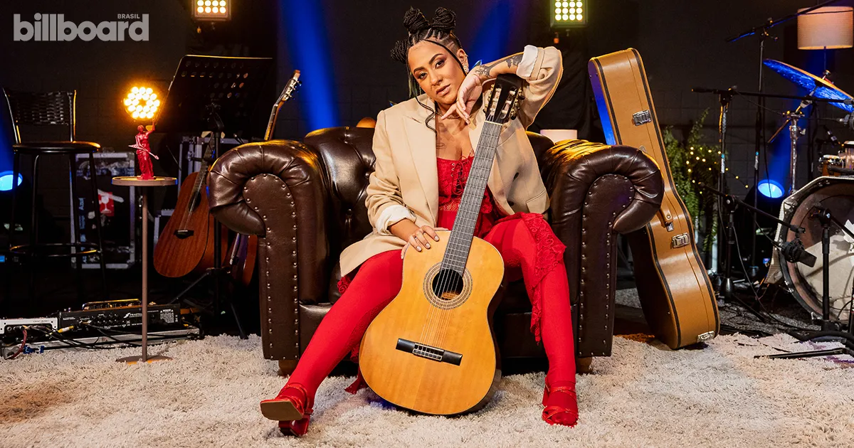Lourena posa com violão no palco do Estúdio Billboard. Crédito: Divulgação